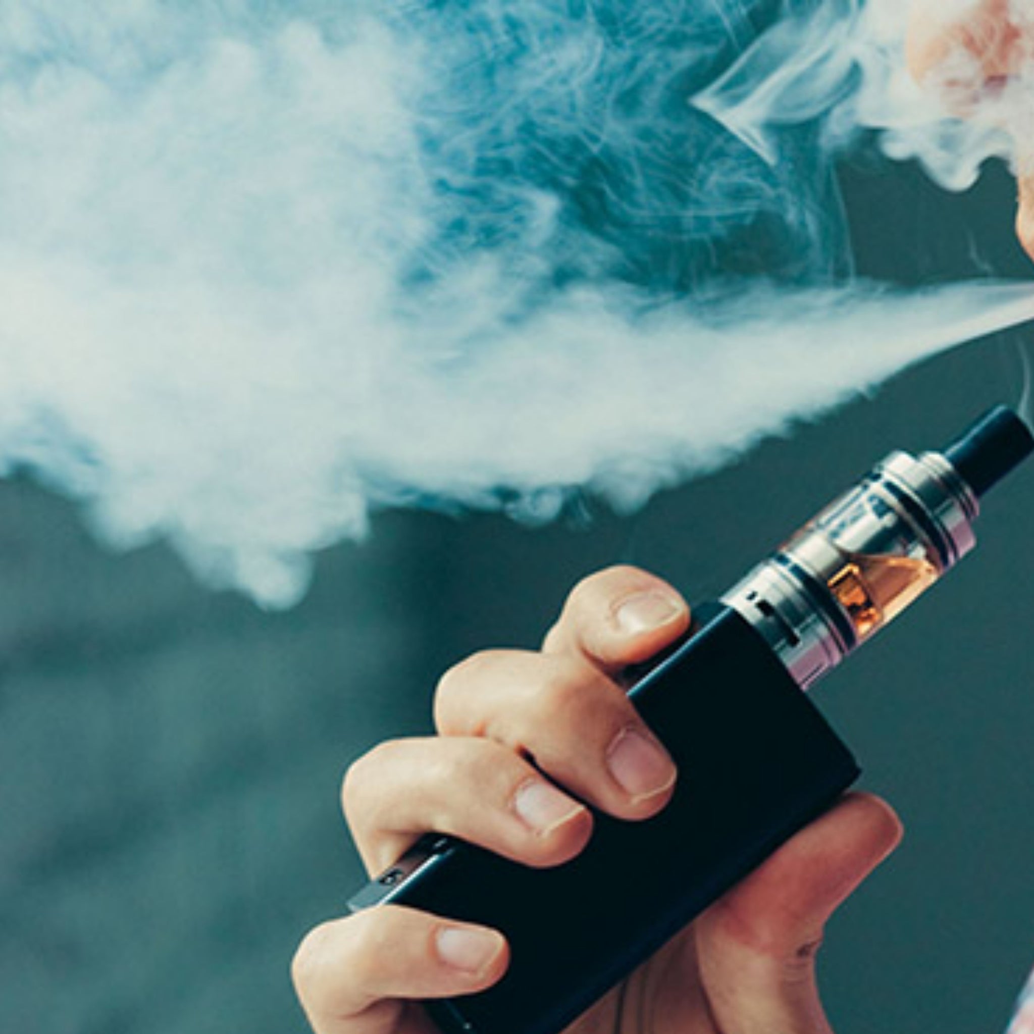 Hand holding vaporizer with smoke